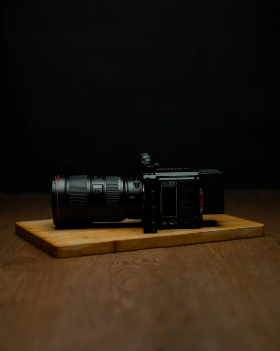 a camera on a wooden shelf on the floor