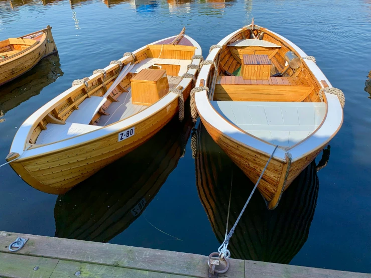 a rowboat is tied to the side of another boat