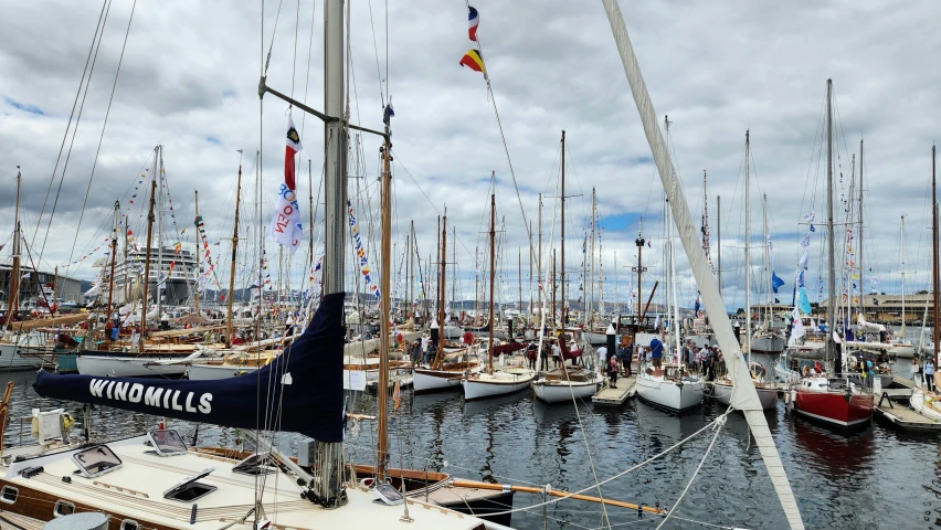 several sail boats docked in the water in a harbor