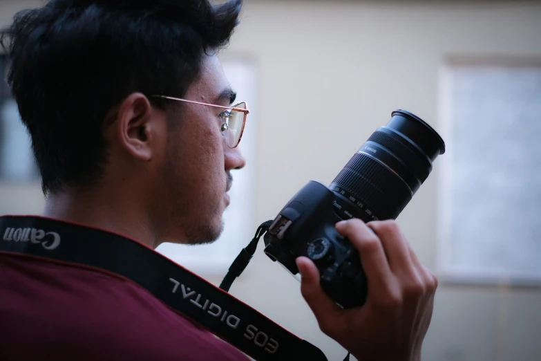 a man holding a camera up to his face