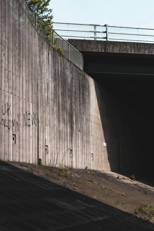 a person with a skate board going into an enclosed tunnel