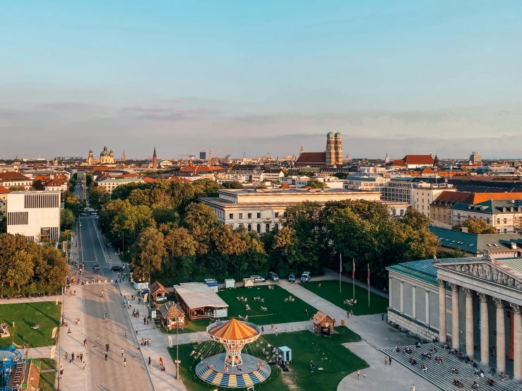 an aerial s of a park and buildings with people walking around it