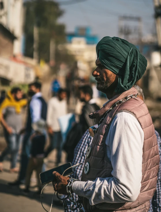 an old man in a turban standing on the street