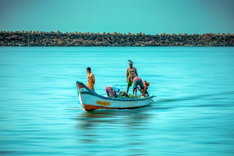 two men riding in a small fishing boat on blue water
