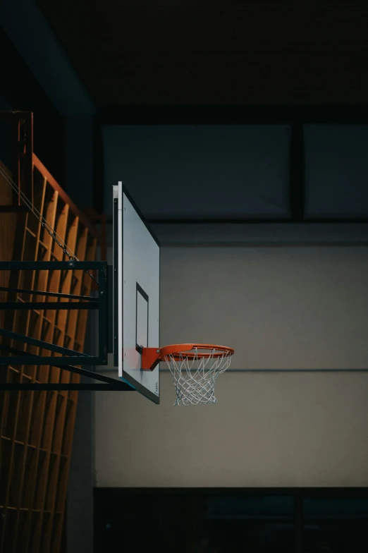 a basket ball hoop in front of a wall mounted basketball net