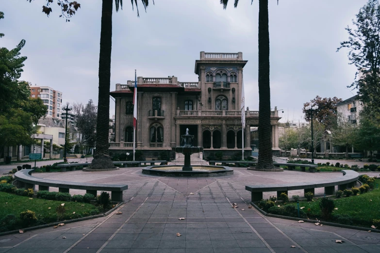 a big fancy house with large trees around it