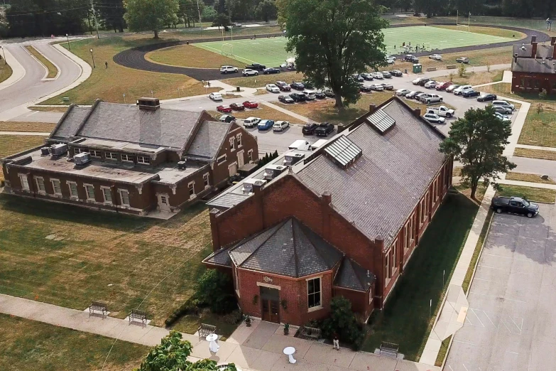 a large red brick building sitting next to a parking lot