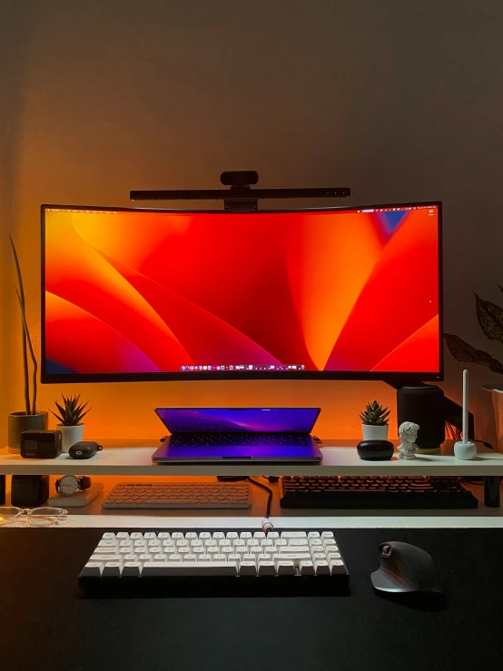 a large computer monitor on a desk, with keyboard and mouse