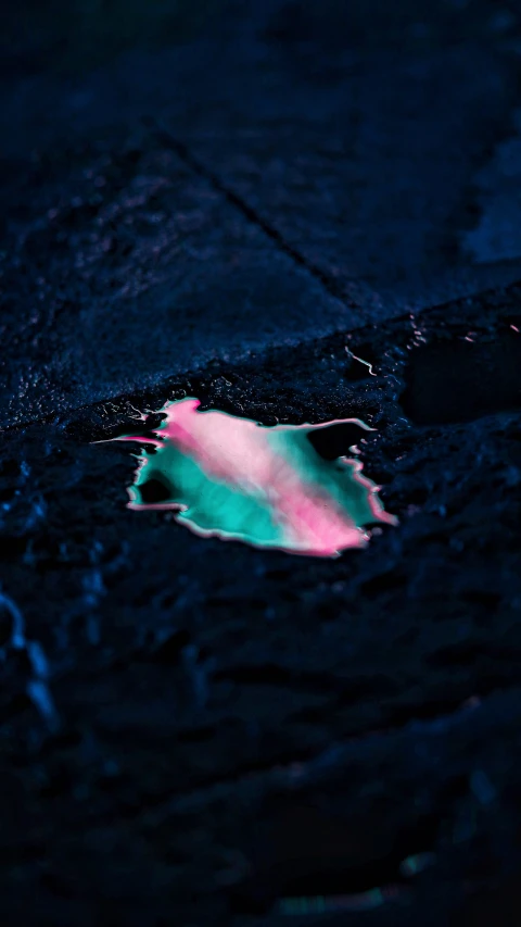 a close up of a colored substance on the ground