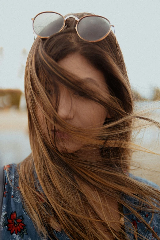 a woman in the wind and some sort of long hair