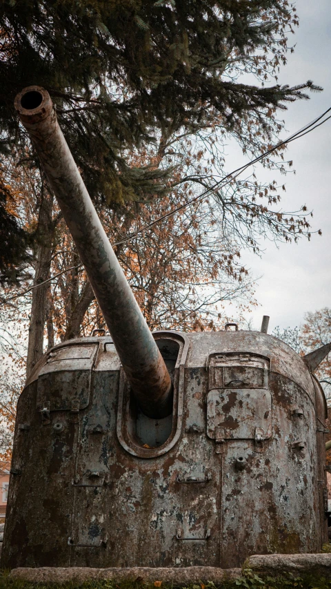 a large rusted cannon sitting on top of a wooden structure