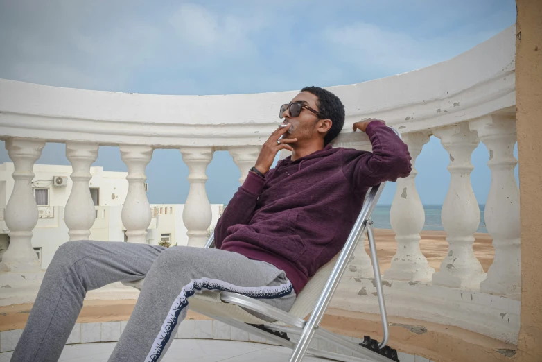 a man sitting in a chair with his legs crossed