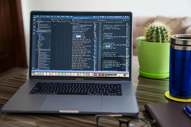 a laptop is displaying code search, on a wood desk