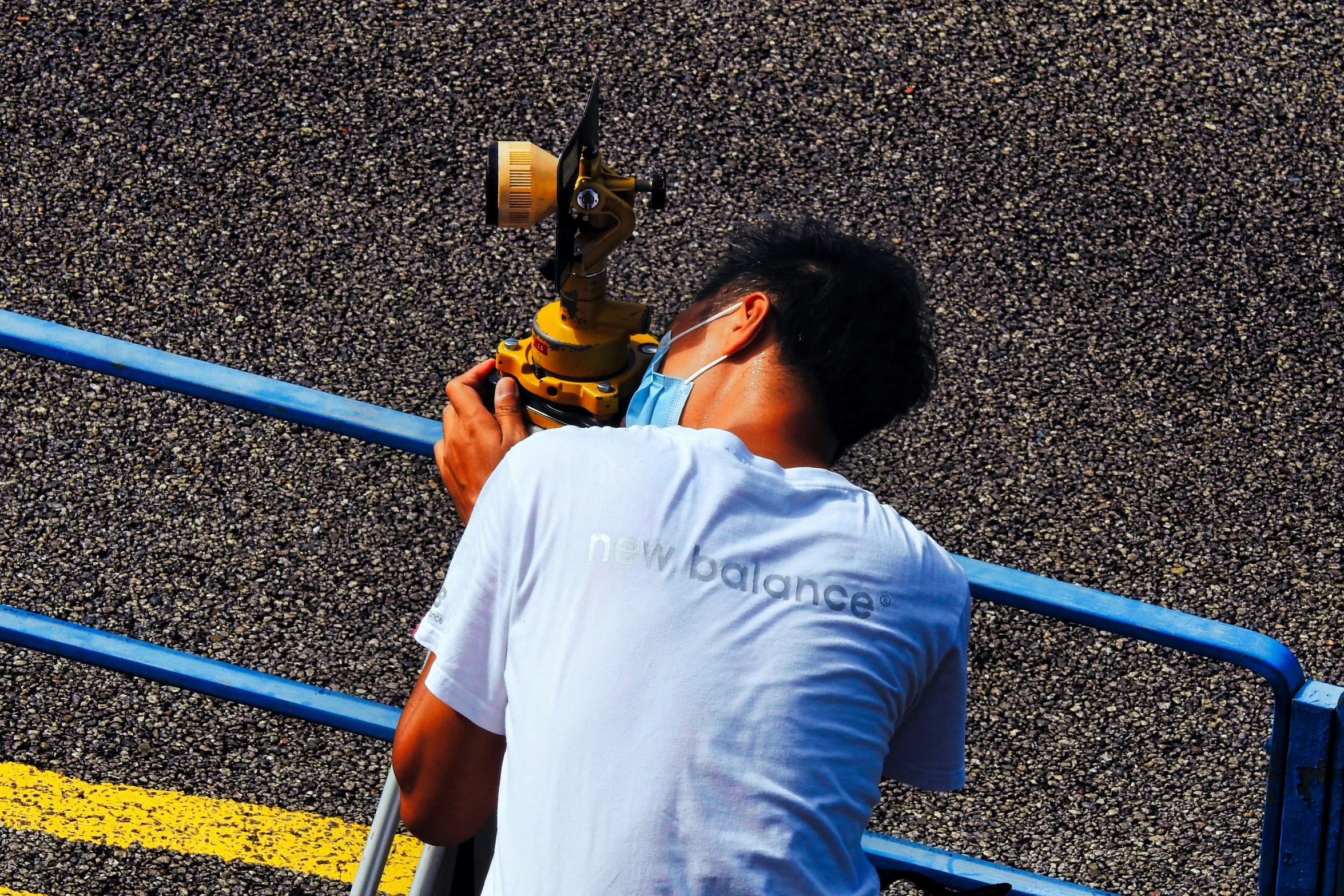 a man painting on the side of a road