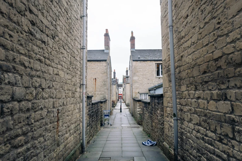 a long brick road is between buildings