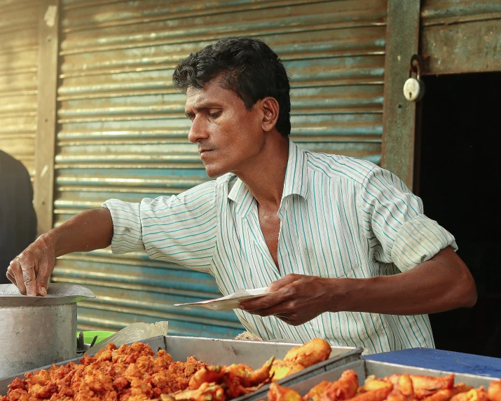 a man cooking food in an open kitchen