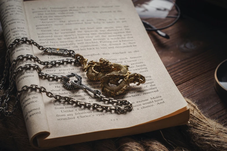 a book open with chains on it on top of a table