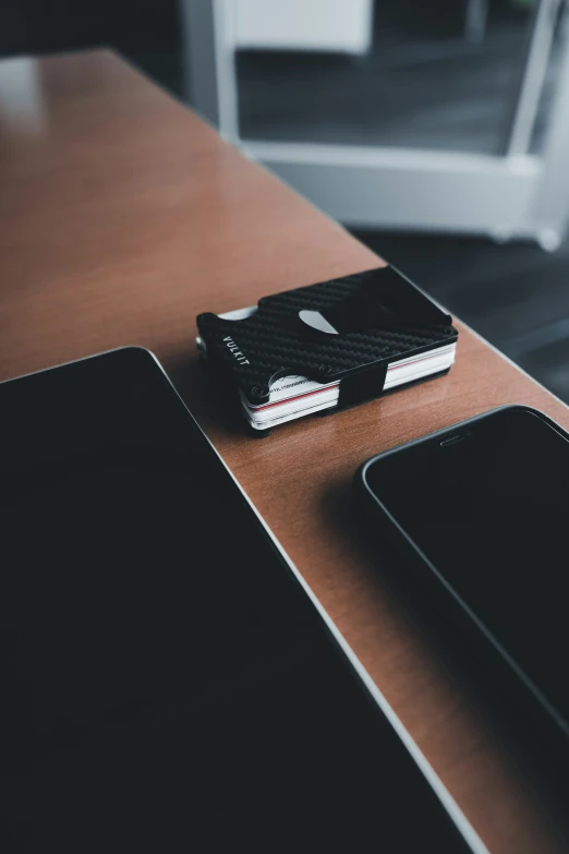 a tablet and cell phone sitting on a table