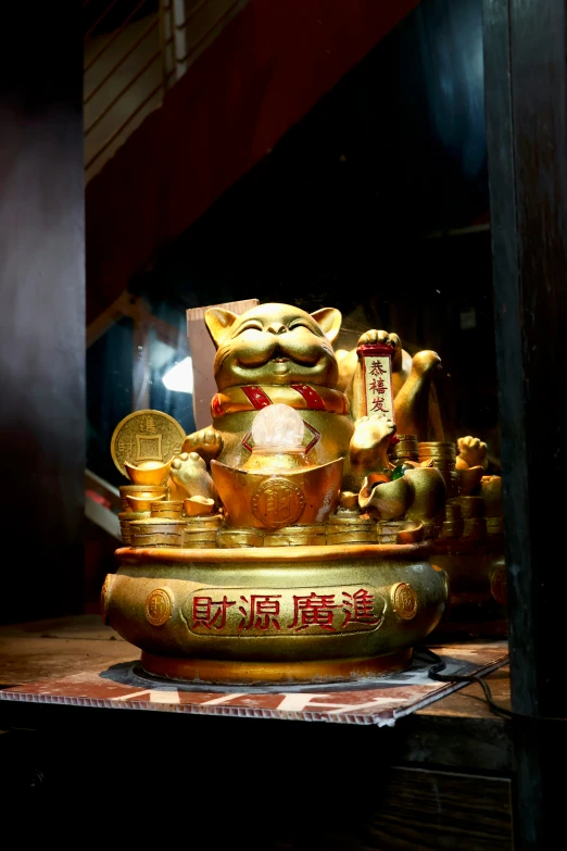 a golden statue on display near other items