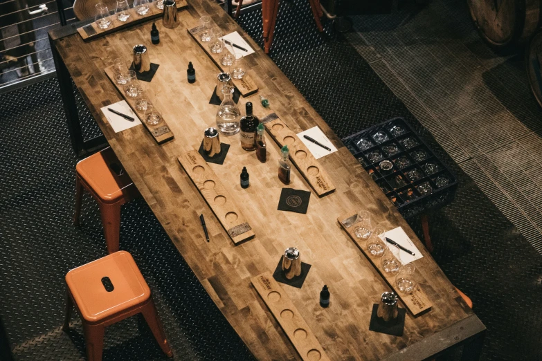 an old style wooden table with many pieces of tools on it