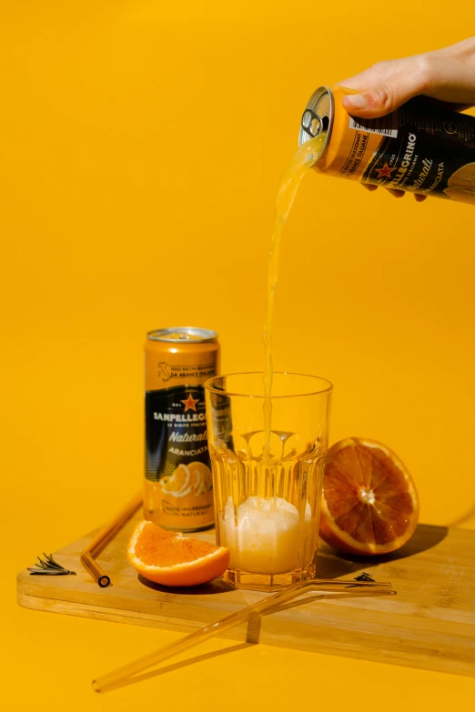 a person pouring a drink into a glass