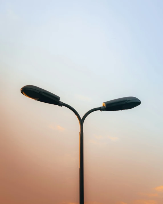 two light posts with street lights on a pole