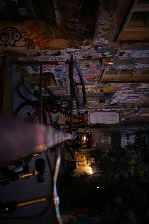 an unfinished building with bikes in it and lights from underneath