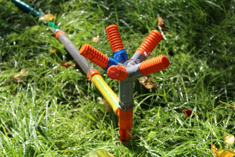 a plastic toy with colorful handles on the grass