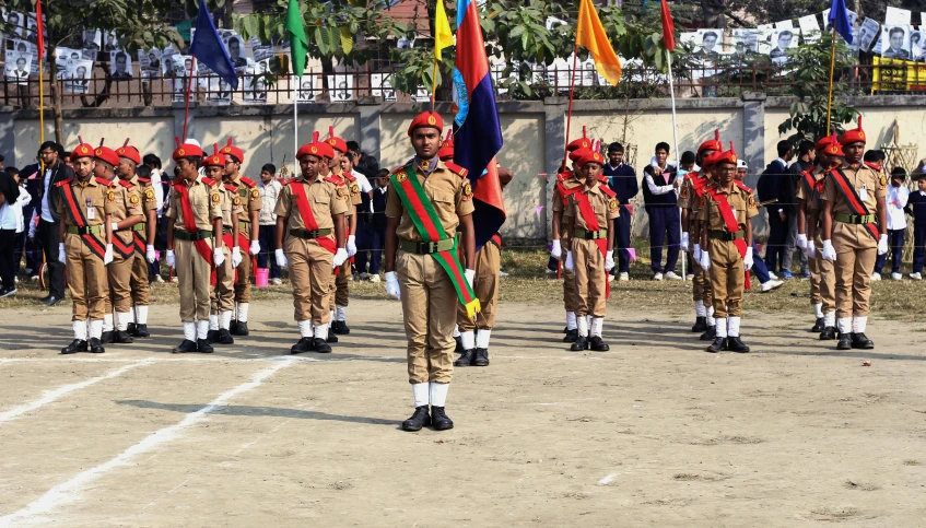 men in uniform and medals march down a street