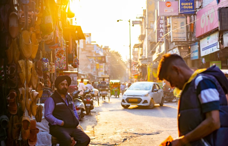 a street scene with pedestrians and cars and buildings