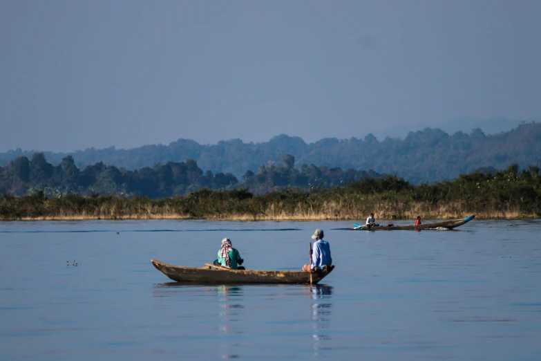 three people in the boat and two people sitting there