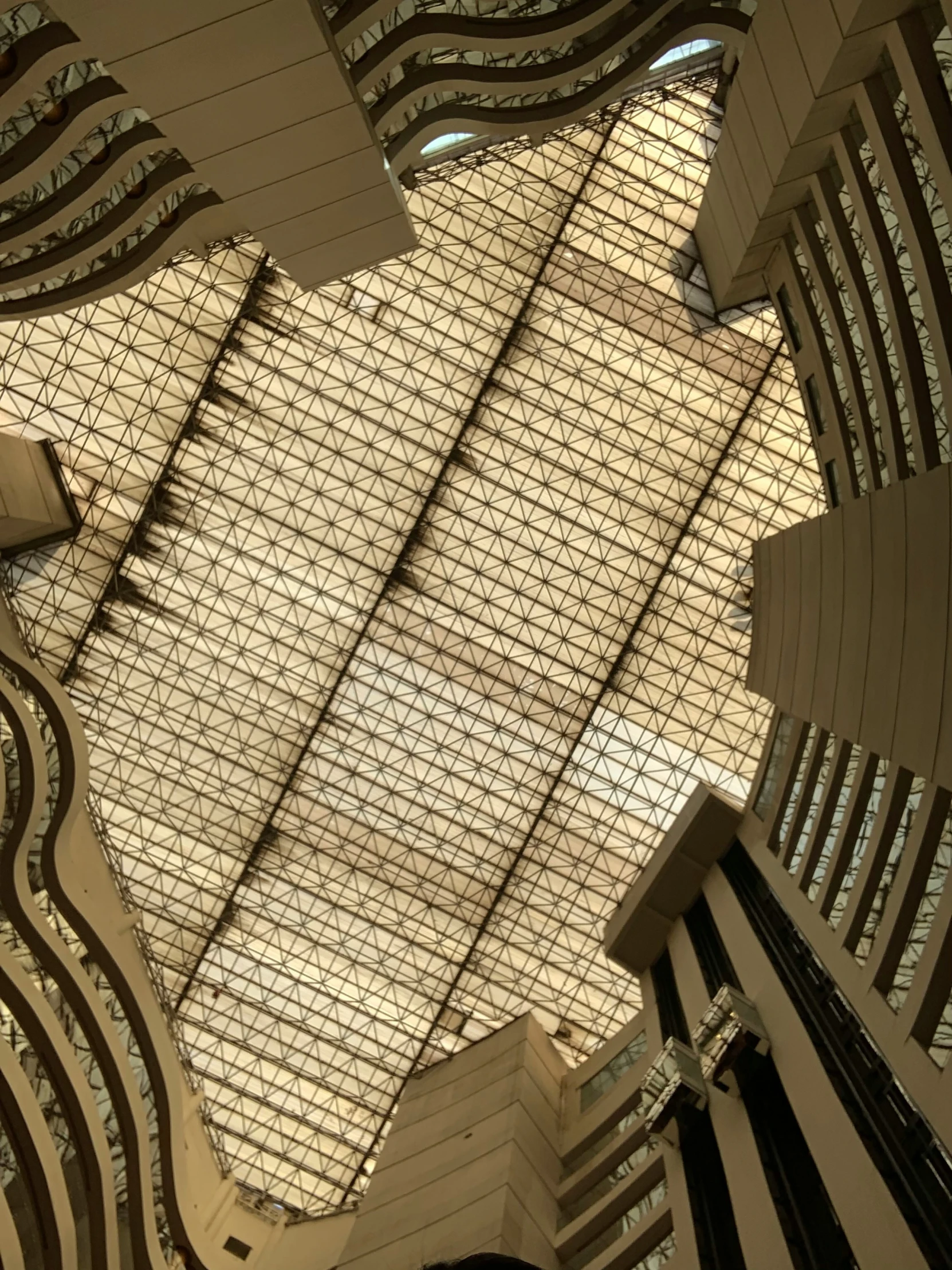 an upward view of an indoor ceiling with a skylight