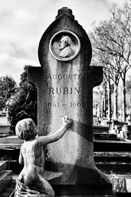 a little boy is cleaning the headstone of a statue