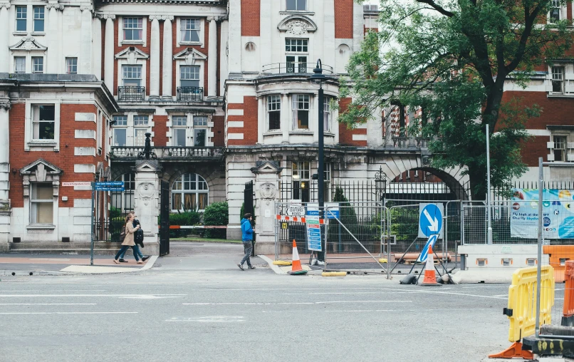 two men are on the street in front of a building