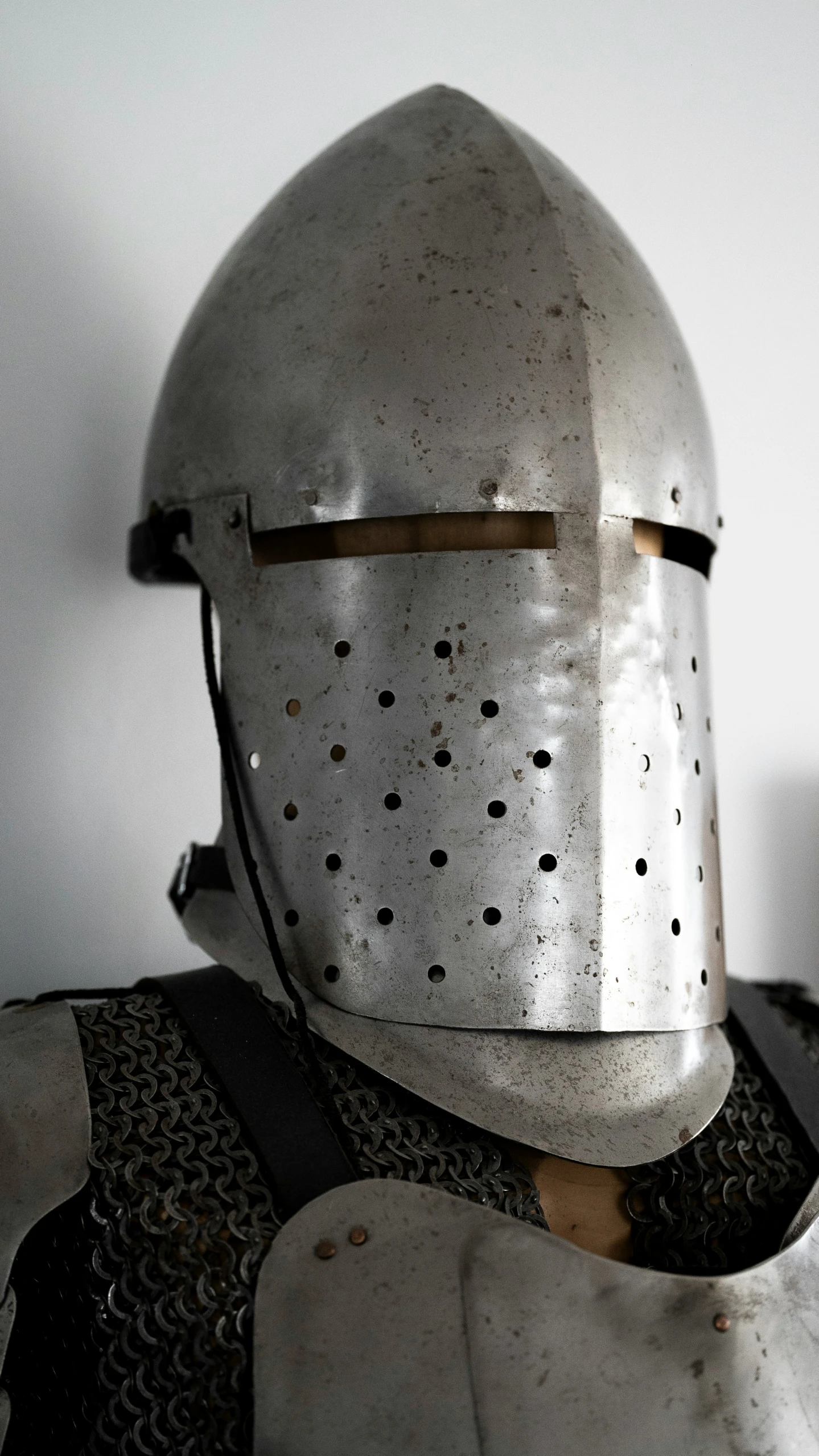 a very old helmet on a white surface