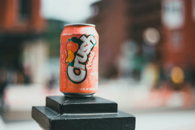 an orange can on top of a wooden block