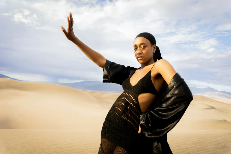 a woman poses in the desert for the camera