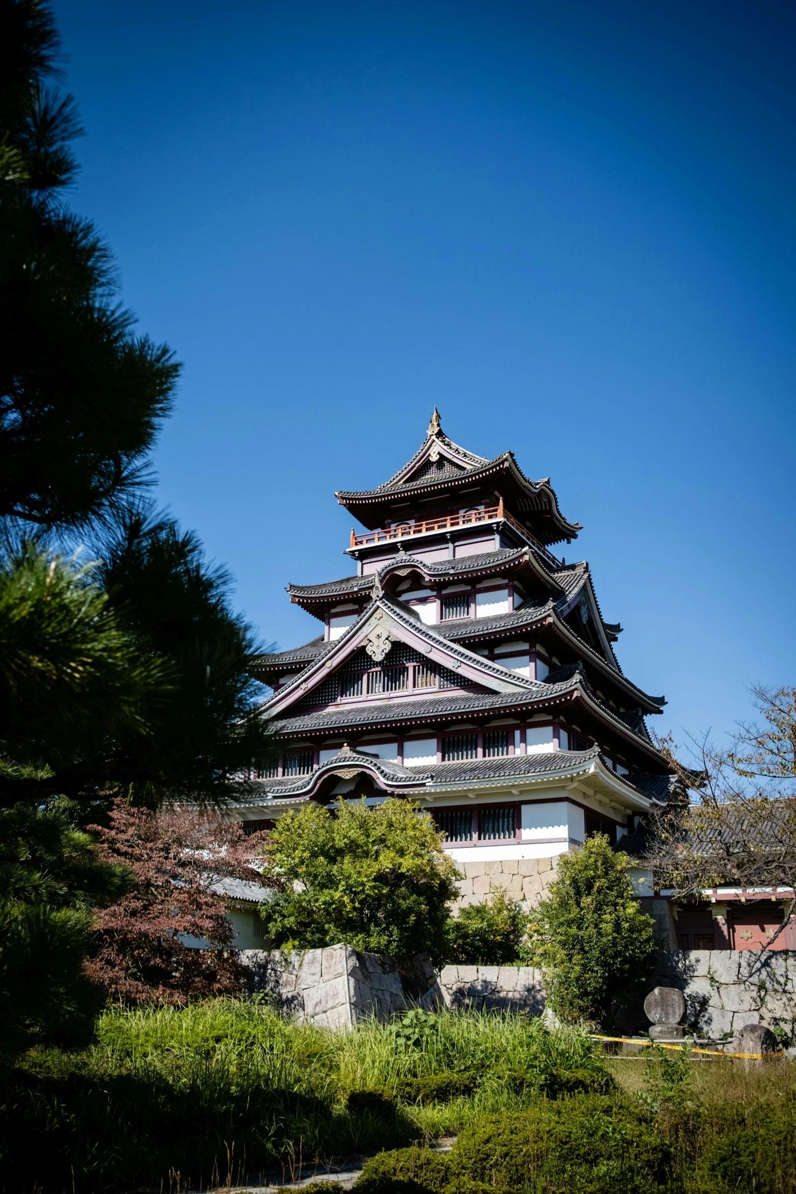 an asian building sitting in front of some trees