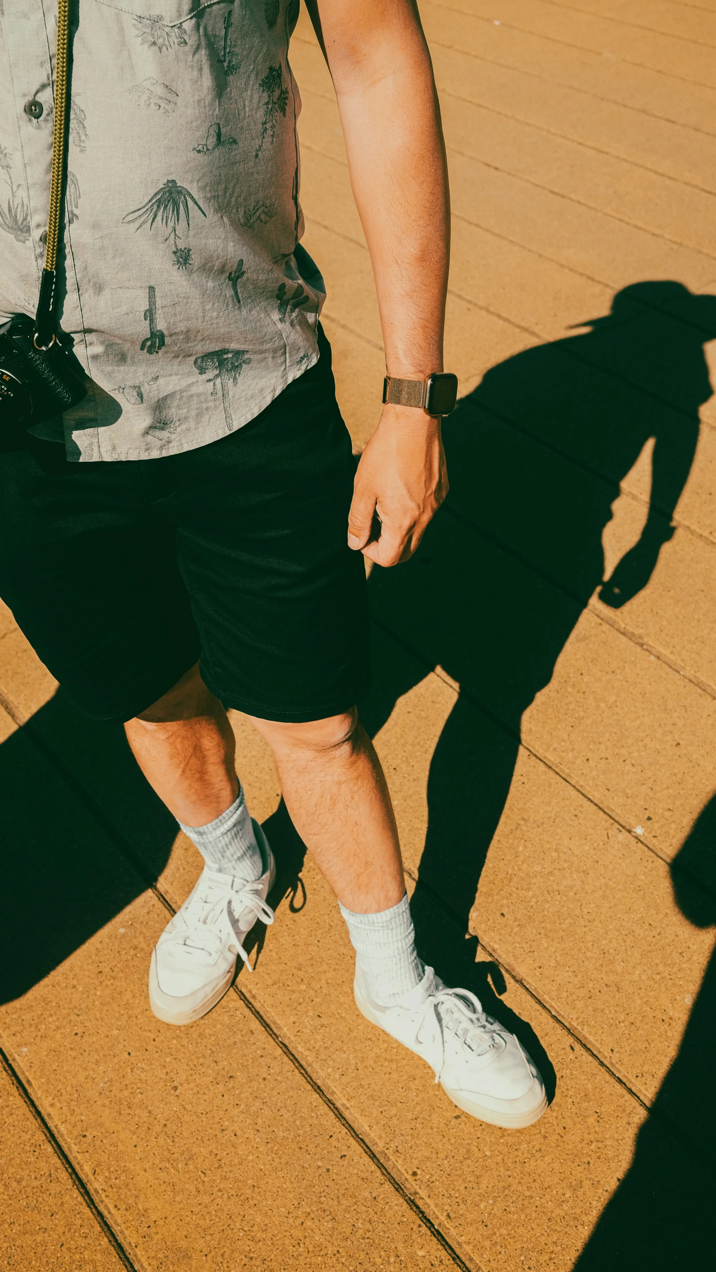 the young man is wearing black shorts and a white shirt