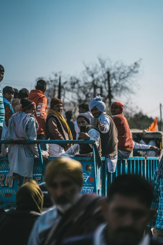 a group of people standing at a fence