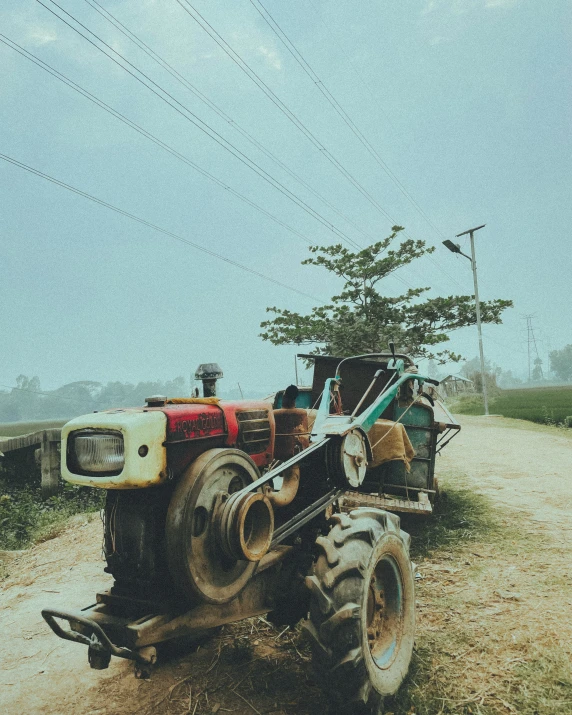 an old vehicle is on the side of a dirt road