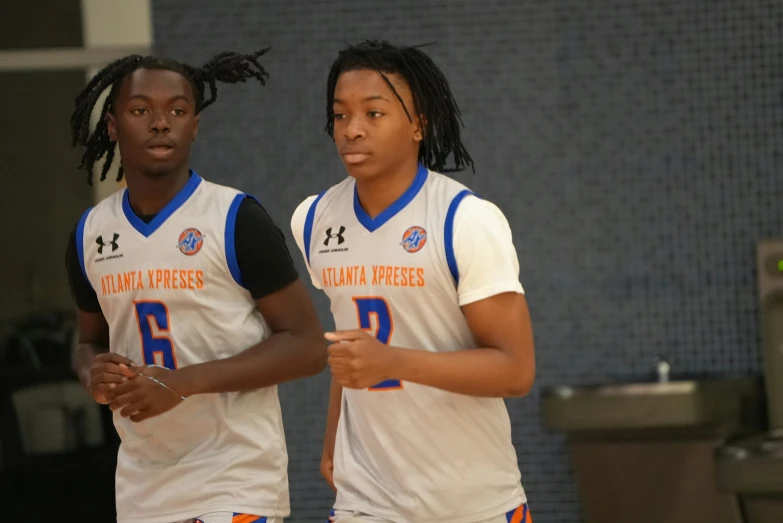 a couple of men standing next to each other on a court