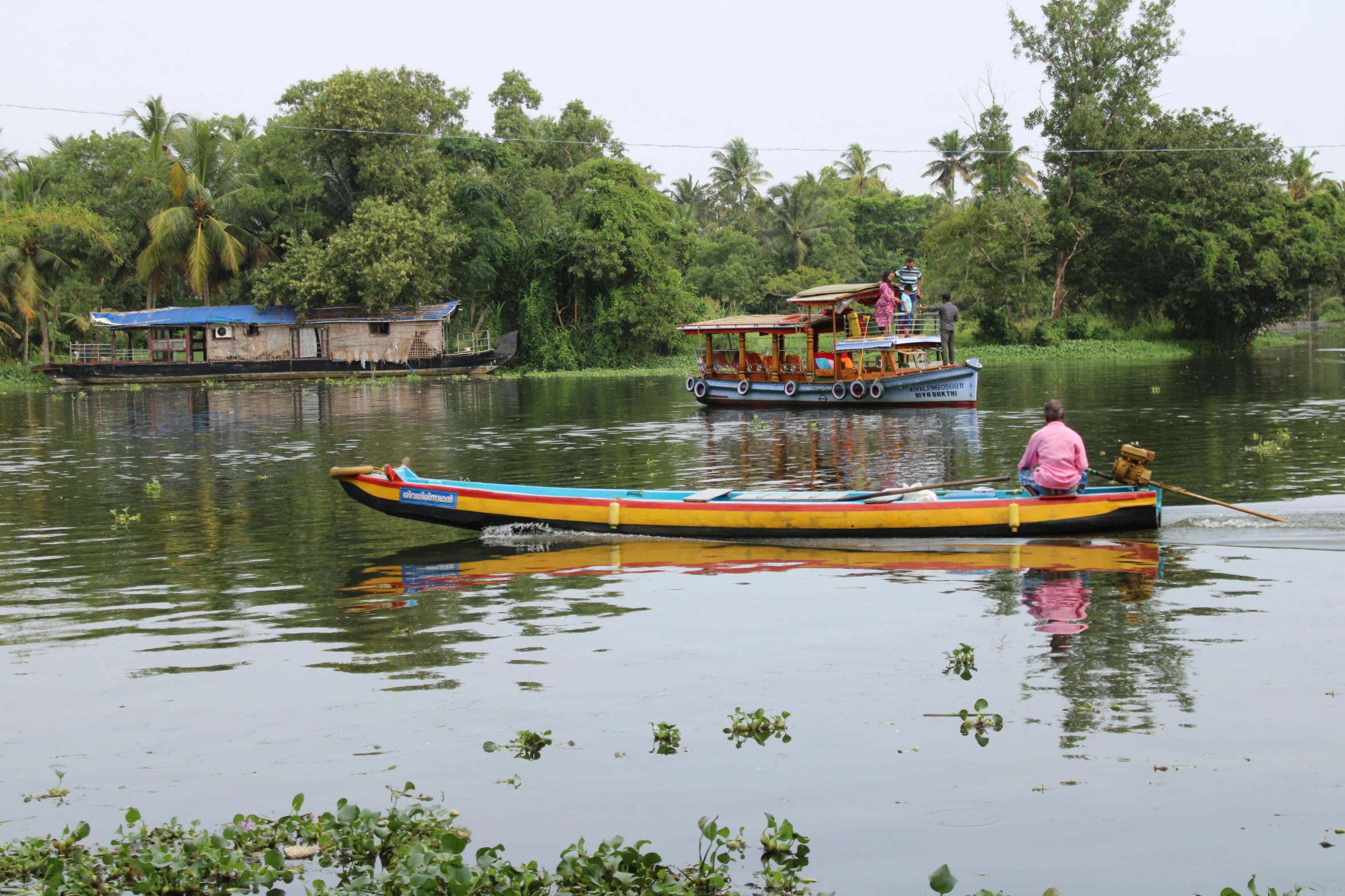 two small boats with passengers are on a river