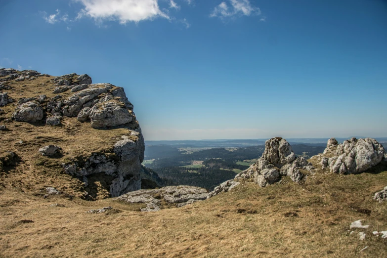 the large rocks are standing alone on the mountain