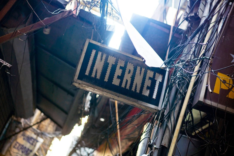 an old sign sitting in a room near wires