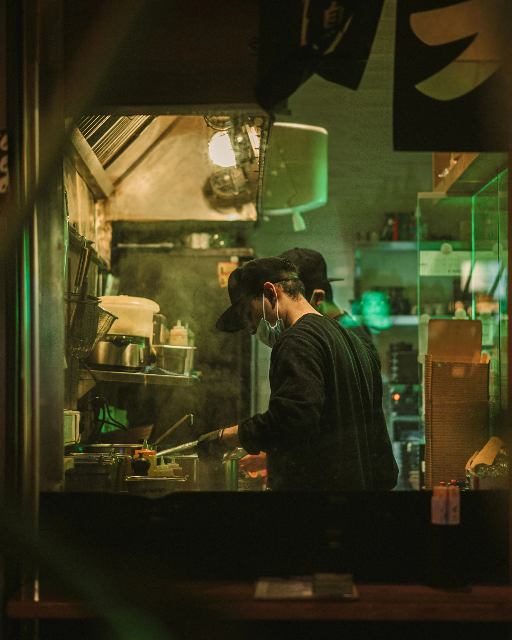 a kitchen with a chef in the middle at night