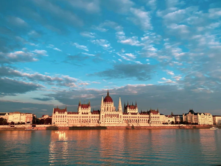 a castle stands on a hill overlooking the water