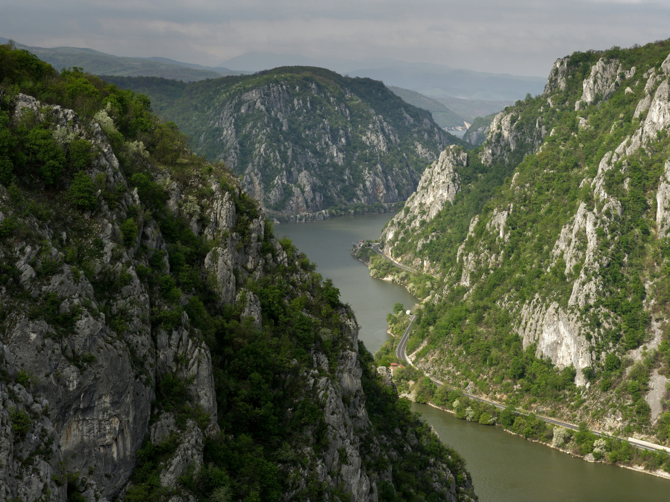 an area with a river, mountains and trees