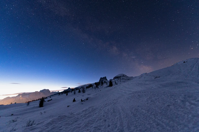 some snow and some sky stars and trees