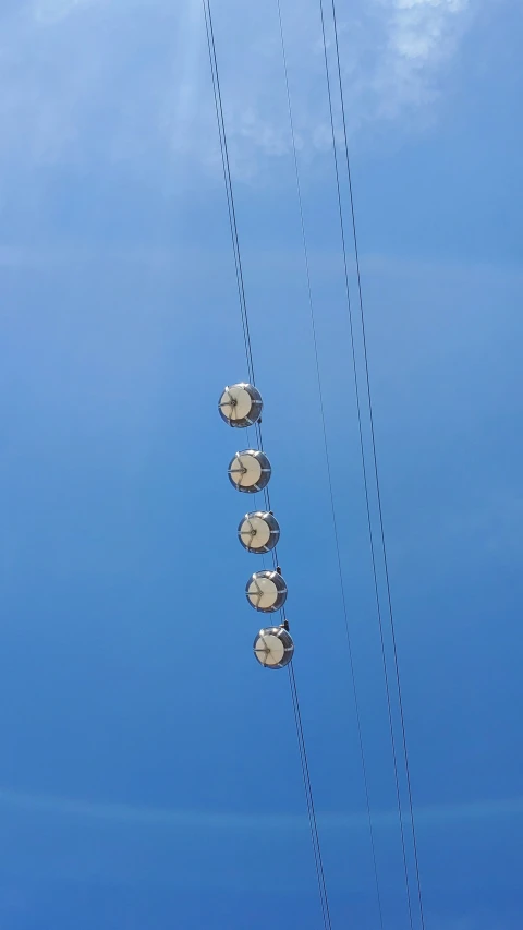 some poles with signs attached in the sky